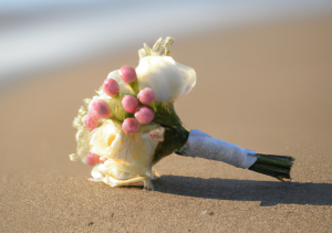 bouquet of flowers on beach sand